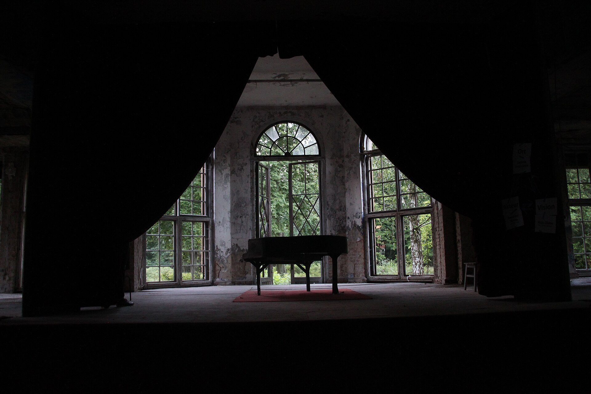 Piano on a worn stage inside Heilst&auml;tte Grabowsee.
